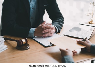 Teamwork of business lawyer meeting working hard about legal legislation in courtroom to help their customer. - Shutterstock ID 2137459909
