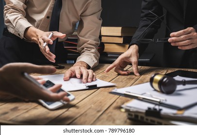 Teamwork of business lawyer meeting working hard about legal regislation in courtroom to help their customer. - Shutterstock ID 789796180