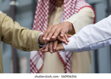 Teamwork Of Business People United Hands Together , Concepts Of Saudi Arabia Business Culture.