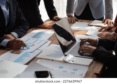 Teamwork with businessman analyzing cost graphs on table at conference room. - Powered by Shutterstock