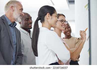 Teamwork, Collaboration And Business People With Sticky Notes In Office Brainstorming On Moodboard, Storyboard Or Glass Wall. Work Team, People Or Staff Writing Or Planning Together On Vision Board.