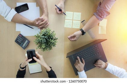 Teamwork Collaboration With Top-down Desk View At Office.  Brainstorming And Setting Goals Working Together.