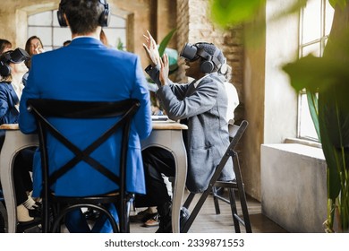Teamwork colleagues using virtual reality headset inside business office - Multiracial people having fun with vr AI technology - Future and articificial intelligence concept - Focus on girl face