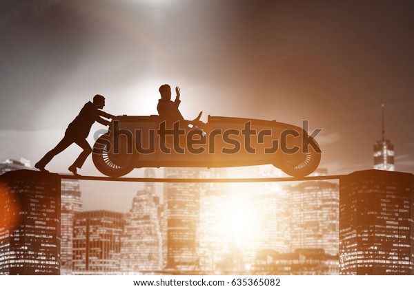 Teamwork concept\
with businessman pushing\
car