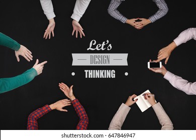 Teamwork concept - top view of six people work on a blackboard.