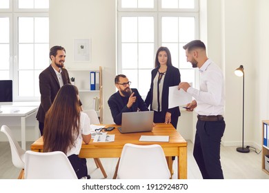Teamwork, cooperation, startup, development concept. Group of positive business people coworkers discussing new project or startup together in office interior - Shutterstock ID 1912924870