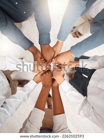 Teamwork, diversity and group holding hands in circle for support, trust and team building together. Business people in huddle standing in solidarity at office workshop and commitment goal from above