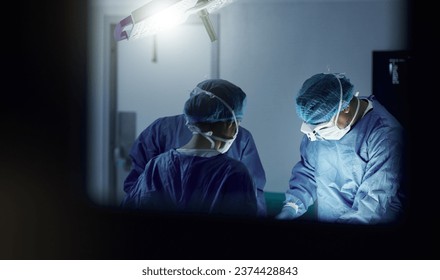 Teamwork, emergency and doctors in a hospital for surgery together, working in theater to save a life. Medical, healthcare and a surgeon team in the operating room of a clinic for an operation