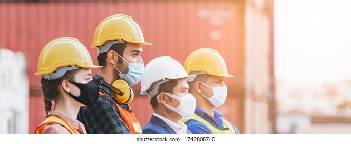 Teamwork engineer technician and foreman and partner wearing protection face mask and safety helmet in cargo container shipping area, Work successful. Crop image banner size.