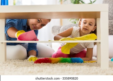 Teamwork family cleaning home with colored mops - Powered by Shutterstock