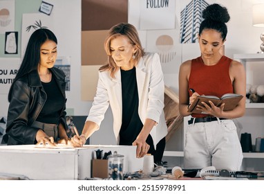 Teamwork, fashion designer or women drawing in small business for notes, pattern ideas or creative clothes. Sketch, production stylist or people in design agency for boutique, modern style or startup - Powered by Shutterstock