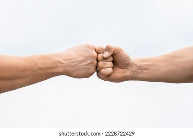 Teamwork and friendship. Partnership concept. Man giving fist bump. Bumping fists together. Fist Bump. Clash of two fists. Concept of confrontation, competition. Gesture of giving respect or approval.
