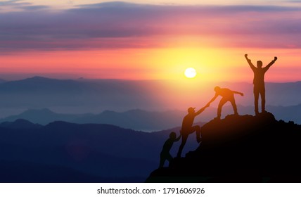 Teamwork Helping Hand Trust Assistance Silhouette In Mountains, Sunset. Team Of Climbers Man Hiker, Help Each Other On Top Of Mountain, Business Concept.