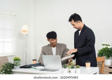 Teamwork and Idea Sharing. Two colleagues exchanging thoughts and strategies in a bright office environment.
