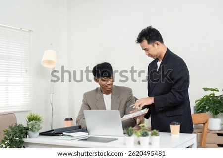 Teamwork and Idea Sharing. Two colleagues exchanging thoughts and strategies in a bright office environment.