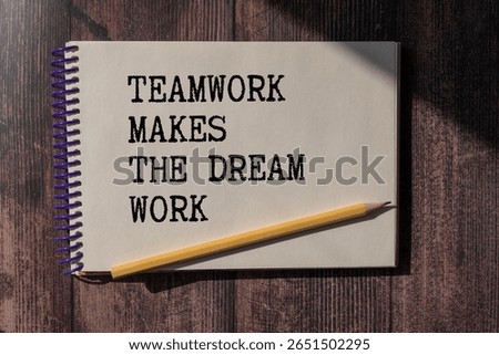 Teamwork Makes The Dream Work text on notepad, concept background