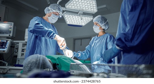 Teamwork, medical and doctors working on a surgery for healthcare treatment in a theatre room. Collaboration, career and professional surgeons doing an operation on a patient in a hospital or clinic.