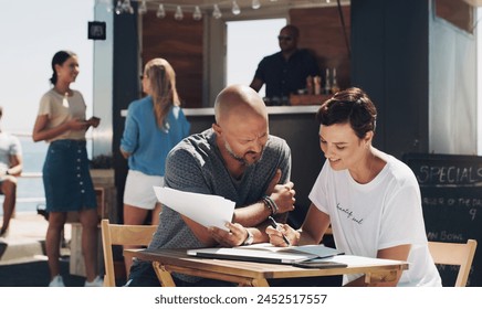 Teamwork, meeting and small business owners with documents at food truck for conversation, planning or discussion on menu. Cafe, manager man and employee woman for collaboration, startup or talking - Powered by Shutterstock