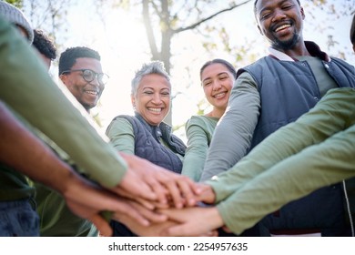 Teamwork, motivation and huddle with senior friends hiking together in the forest or woods from below. Fitness, exercise or nature with a mature man and woman friend group putting hands in a circle - Shutterstock ID 2254957635