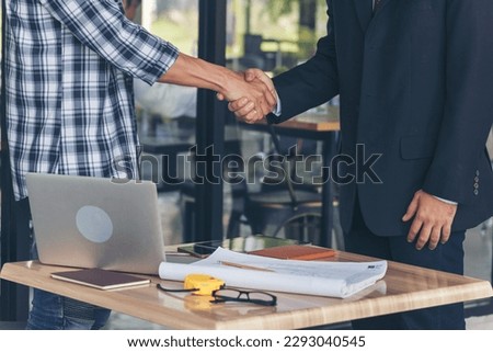 Teamwork partner two men team shaking hands together. Businessman contractor handshake with Business Partner Trust Partnership. Industrail people contractor dealing mission team meeting office desk