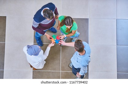 Teamwork of partners. Concept of integration and startup with puzzle pieces, students, work collegues