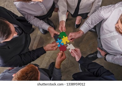 Teamwork of partners. Concept of integration and startup with puzzle pieces.
