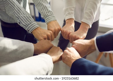 Teamwork, partnership, cooperation concept. Group of business partners office workers making cirle with fists meaning support unity in office and business