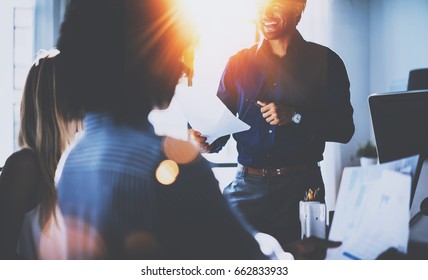 Teamwork People Concept.Young Team Of Coworkers Making Great Business Discussion In Modern Coworking Office.Hispanic Businessman Talking With Partners.Horizontal, Blurred Background, Flares