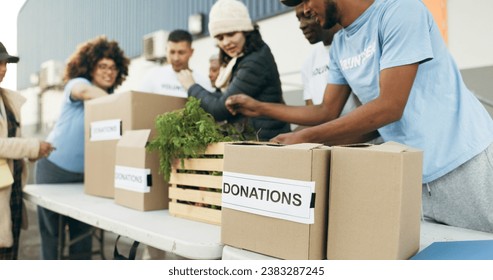 Teamwork, people volunteering and food boxes on table for charity event with care, kindness and trust. Community donation, men and women at ngo with grocery package distribution at non profit project - Powered by Shutterstock