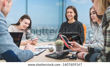 Teamwork in process. Busines team discussing new project sitting in modern office. Coworkers developing company income strategy.