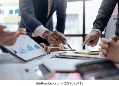 Teamwork process. Business people pointing at business document during discussion at meeting. - Powered by Shutterstock