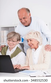 Teamwork - Senior People Working Together On The Laptop