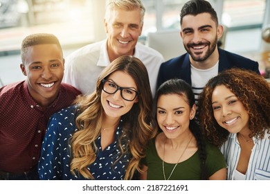 Teamwork, Smiling And Diverse Workers Standing Together In A Creative Workplace. Portrait Of Group Of Casual Businesspeople And Colleagues Looking Happy. Team Of Professionals Ready 