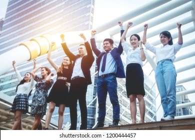 Teamwork strength concept : The company's new generation of business people work together in unity with strength and willpower to fight together for success. - Shutterstock ID 1200444457