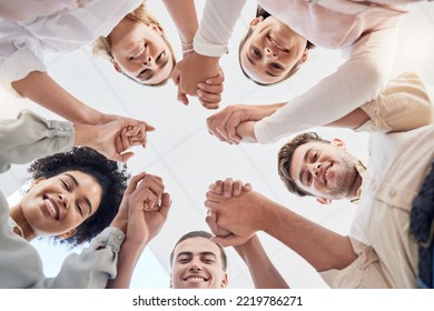 Teamwork, Support And Collaboration Of Happy Employees With Diversity, Synergy And Trust Holding Hands And Looking Down. Men And Women Team Building Circle For Mental Health Mission In Workplace