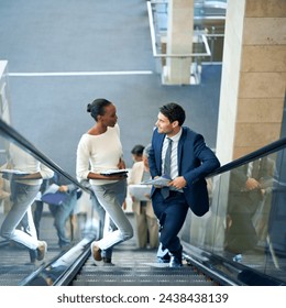 Teamwork, talking or business people on escalator for meeting, travel or paperwork in workplace. Diversity, documents and workers planning for collaboration or project together in office conversation - Powered by Shutterstock