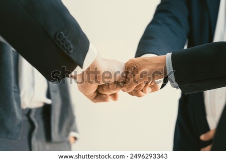 Teamwork, team building, responsibility and equal opportunities. Hand holding together bumping fists in circle as unity symbol.