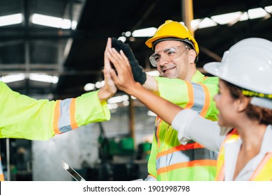 Teamwork and team spirit worker group give high five together corporate trust concept.industry celebrate reward success good teamwork result in factory