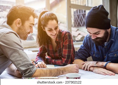 Teamwork. Three young architects working on a project - Shutterstock ID 237302122