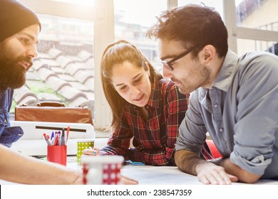 Teamwork. Three young architects working on a project - Powered by Shutterstock