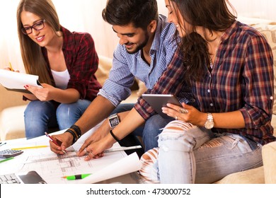 Teamwork. Three young architects working on a project. Startup concept.