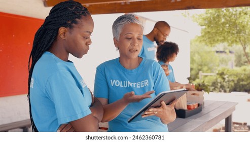 Teamwork, volunteer and women on tablet for charity discussion, meeting and planning. Volunteering, collaboration and people in digital tech talking for donation, ngo business and community service - Powered by Shutterstock