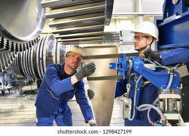 Teamwork - Workers Manufacturing Steam Turbines In An Industrial Factory 