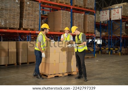Teamwork of workers working in large warehouse retail store industry.Rack of stock storage. Interior of cargo in ecommerce and logistic concept. Depot. People lifestyle. Shipment service for container
