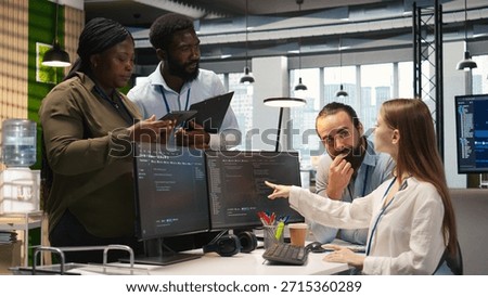 Teamworking programmers developing software applications, working together to optimize code. Tech startup team doing brainstorming in office, using AI to solve bottlenecks, camera A