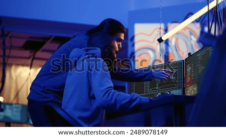 Teamworking spies contracted by government to do international espionage warfare on other countries, using advanced technology computer equipment to infiltrate past protection firewalls