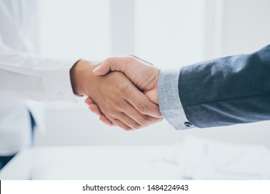 Teamwork,partnership and Social connection in business join hand together,Finishing up a meeting,handshake of happy business people after contract agreement to become a partner,collaborative teamwork.
