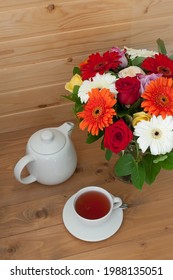 Teapot, Cup And A Beautiful Spring Bouquet On A Wooden Table. Tea Party.