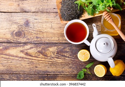 Teapot And Cup Of Tea With Mint And Lemon On Wooden Table, Top View