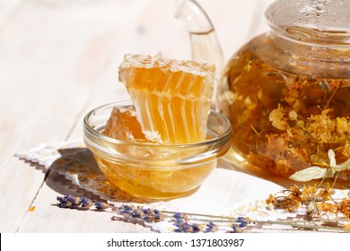 teapot linden lavender tea and dry linden and lavender flowers on white wooden table with Fresh Honey comb. remedy for flu and cold. high key photo. bee products by organic natural ingredients concept